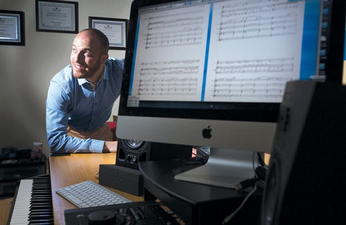 Sound engineer, musician, artist, actor: Dan Perelstein ’10 sits at computer.